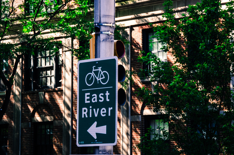 Canvas:  City Charm: East River Sign amidst Red Brick Splendour