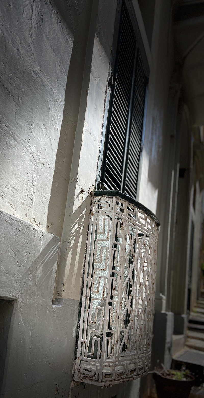 Classic Frame:Sunlit Elegance: Maltese Iron Balcony